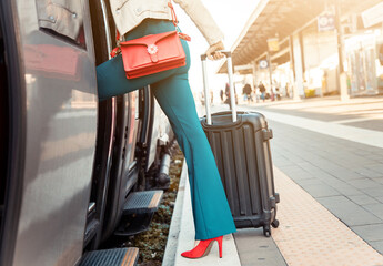 Legs's close up of a business woman getting on the train with bag and trolley bag - Woman on the...