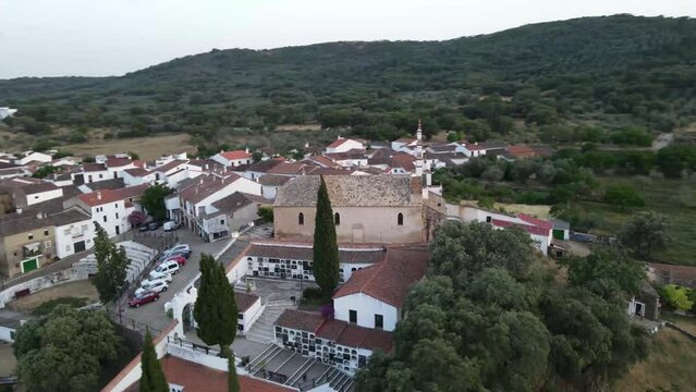 Dron shot Espania Spain church open shot sun afternoon sky buildings smog water lake paning left moutan sea covid trees tree front green blue back cars rush hour road covid empty sun sunset.mp4