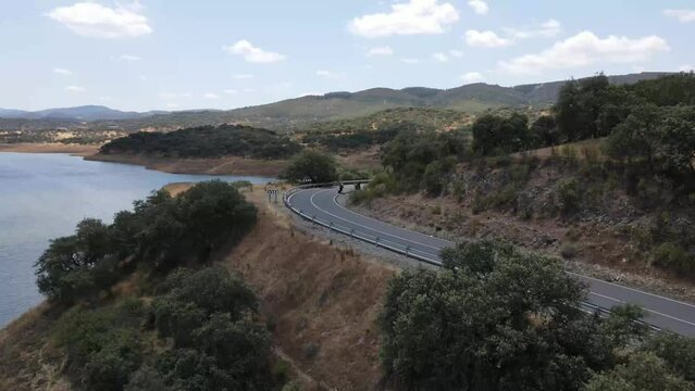 Dron shot Espania Spain Tenerife open shot sun afternoon sky buildings smog water lake paning left motorcycle motors covid trees tree front green bus back cars rush hour road covid empty sun vol.2.mp4