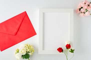 Envelope with card with roses on white background