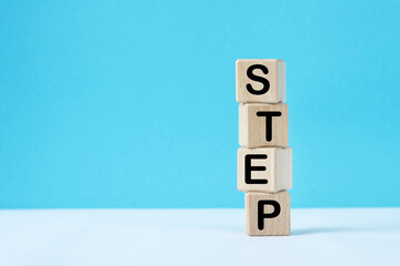 Wooden cubes with word step.