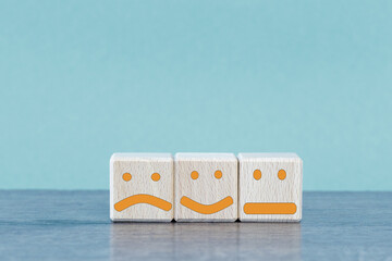 three wooden cubes with different faces.