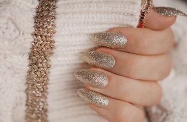  Beautiful golden nail manicure. Holiday style bright manicure with glitter. © dmitri_gromov