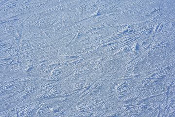 Close up blue ice rink texture with scratches. Ice surface with skating tracks.. Frozen background.Texture. Abstraction.