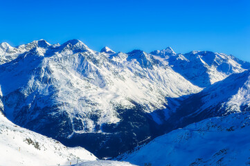Obraz premium Austrian Alps covered with snow during sunny winter day.