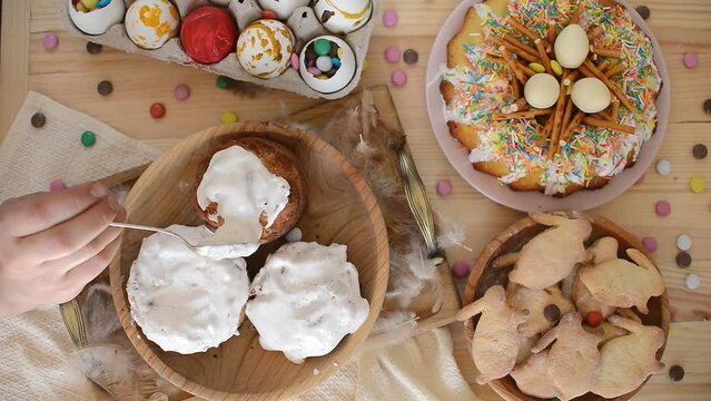 Funny family with kids wearing bunny ears painting eggs on Easter day