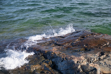 Water splashing over large rock