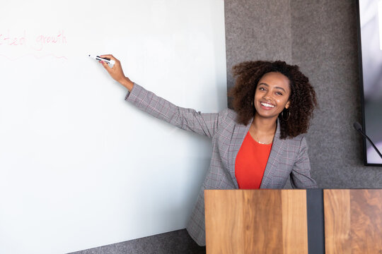 Woman writing on a whiteboard