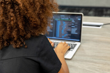 woman coding on laptop