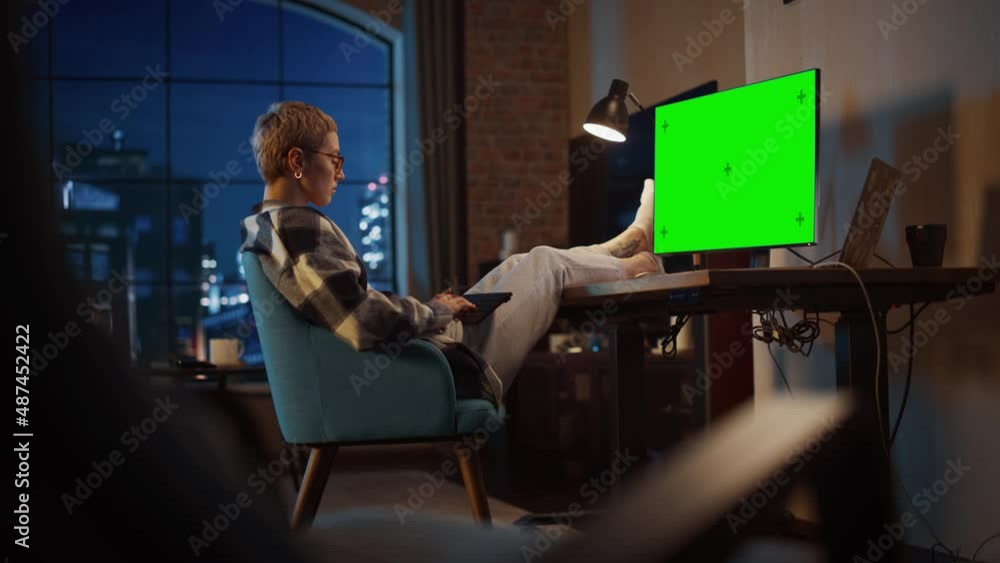 Poster young beautiful female working from home on computer with green screen mock up display. creative fem