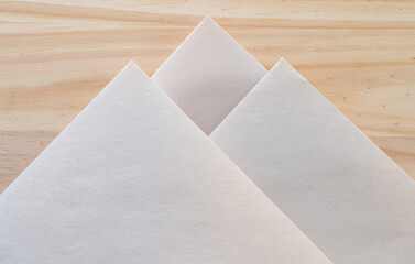 faded pad paper folded into geometric designs on wood
