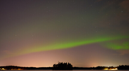Fototapeta na wymiar The Northern Lights on a lake in Finland.