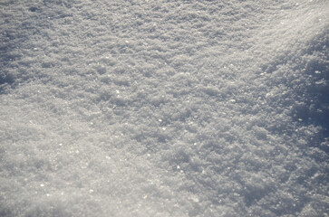 Fototapeta na wymiar Texture of white snow sparkling in the sun