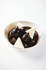 Caramelized figs with cheese a typical Ecuadorian desert, served on a traditional plate on a white background