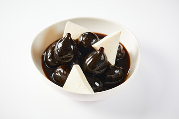 Caramelized figs with cheese a typical Ecuadorian desert, served on a traditional plate on a white background