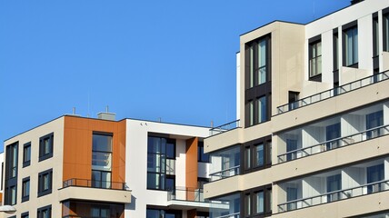 Obraz premium Abstract architecture, fragment of modern urban geometry,. Modern apartment building on a sunny day with a blue sky,. European residential apartment buildings.