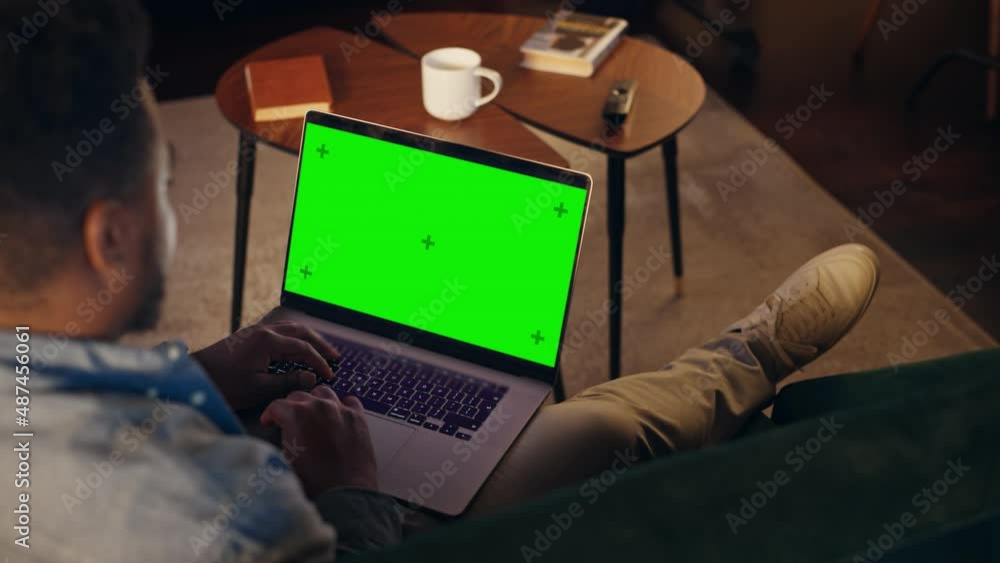 Aufkleber young african american man working from home on desktop computer with green screen mock up display. 
