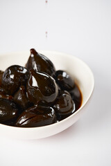 Caramelized figs with cheese a typical Ecuadorian desert, served on a traditional plate on a white background