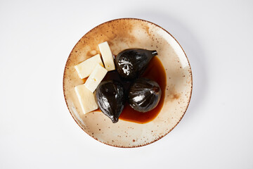 Caramelized figs with cheese a typical Ecuadorian desert, served on a traditional plate on a white background