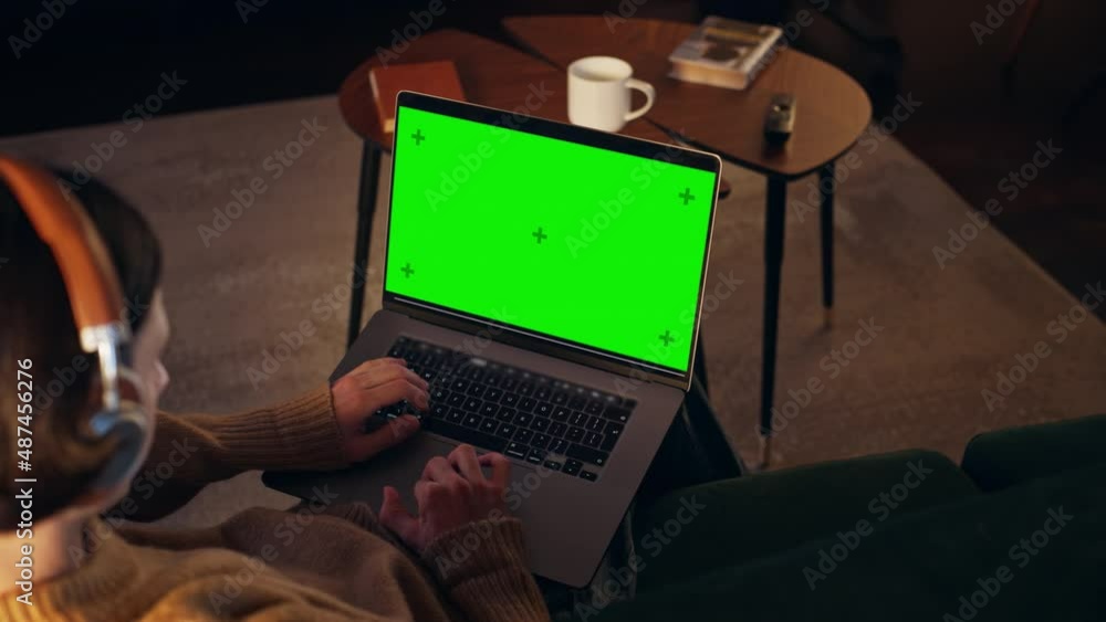 Poster young man working from home on desktop computer with green screen mock up display. creative male wea