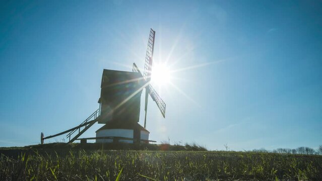 Timelapse of clods and sunshine with traditional windmill in English countryside