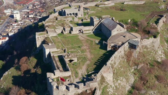 Rozafa or Shkoder castle is a hilltop archaeological park near Shkodra in Albania. Ancient fortress on top of a hill near the city of Skadar. Stone walls of medieval fortification - aerial drone view.