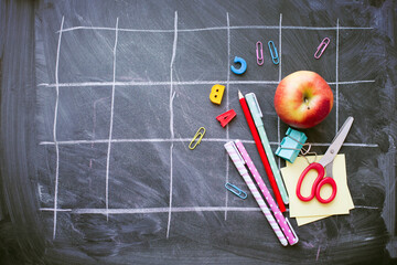 back to school background with black chalk board and school suppilents