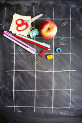 back to school background with black chalk board and school suppilents