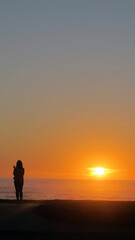 silhouette of a person on a sunset beach