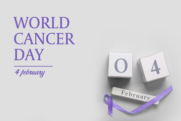 Calendar with date of World Caner Day and awareness ribbon on grey background