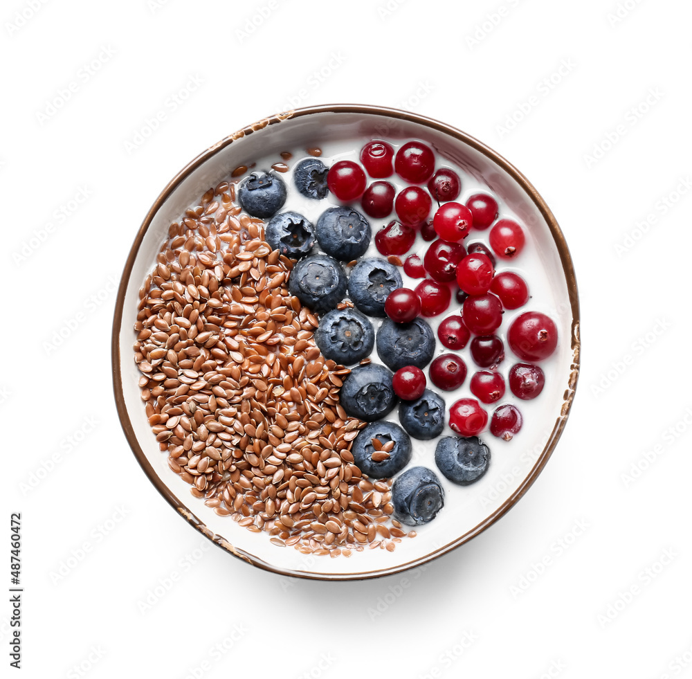 Wall mural Bowl of sweet yogurt with flax seeds and berries on white background