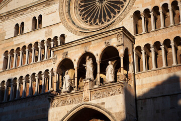 Cremona Cathedral in Cremona, Lombardy is a Catholic church in northern Italy with the white marble statues, the bell tower (Torrazzo) and the seat of the Bishop of Cremona. European architecture. - obrazy, fototapety, plakaty