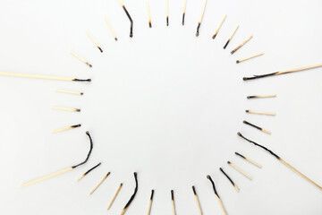 Frame made of burnt matches on white background. Concept of work burnout