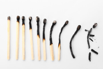 Burnt matches showing different life stages on white background. Concept of different human life...