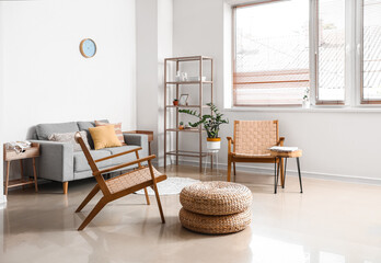Interior of modern living room with sofa and wooden armchairs