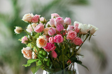 Vase with beautiful roses in room