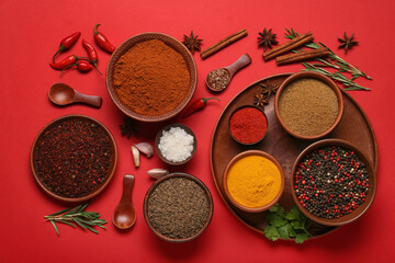 Composition with different spices on red background - obrazy, fototapety, plakaty