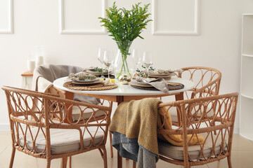 Stylish table setting near white wall