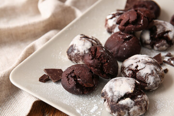 Plate of chocolate brownie cookies on table, closeup
