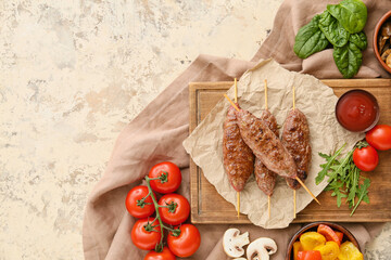 Wooden board of skewers with tasty lula kebab, tomatoes and sauce on beige background