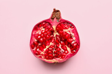 Ripe delicious pomegranate on pink background
