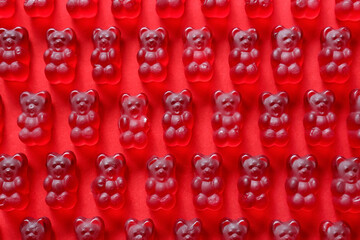 Sweet jelly bears on red background