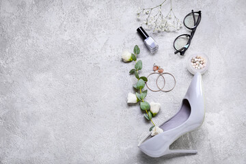 Fototapeta na wymiar Composition with decorative cosmetics, accessories and female shoes for International Women's Day celebration on grey background