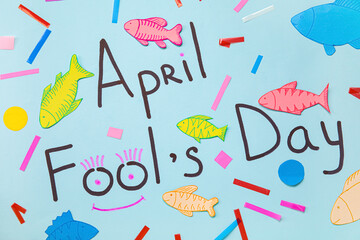 Composition with text APRIL FOOLS DAY and paper decor on color background