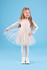 Naklejka premium Cute girl in beautiful dress with diadem on light blue background. Little princess
