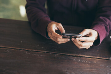 asian man work using cell phone hand holding mobile texting message contact us.chatting,search internet information in office.technology device communication connecting