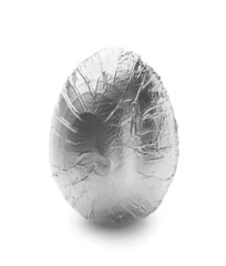 Easter egg wrapped in silver foil on white background