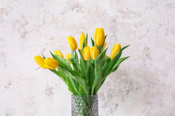Vase with beautiful flowers on grunge background