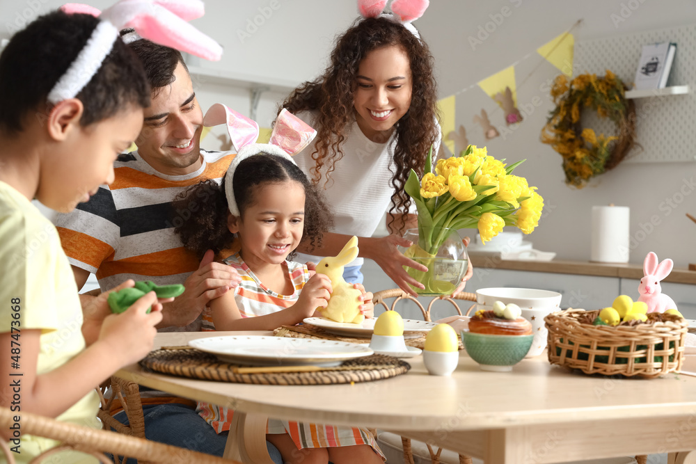 Canvas Prints happy family at dining table in kitchen on easter day