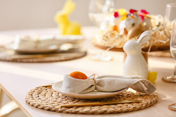Plate with Easter egg and napkin on served dining table